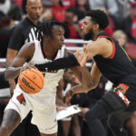 
              Maryland guard Don Carey attempts to strip the ball away from Louisville guard Mike James during the second half of an NCAA college basketball game in Louisville, Ky., Tuesday, Nov. 29, 2022. Maryland won 79-54. (AP Photo/Timothy D. Easley)
            