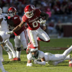 
              Oklahoma running back Eric Gray leaps against Baylor in the second half of an NCAA college football game, Saturday, Nov. 5, 2022, in Norman, Okla. (AP Photo/Nate Billings)
            