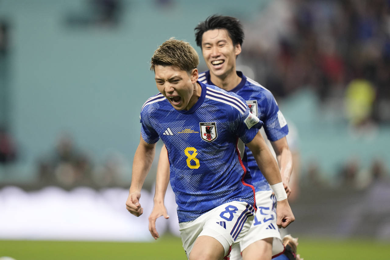 Japan's Ritsu Doan celebrates after scoring his side's opening goal during the World Cup group E so...