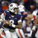 
              Auburn quarterback Robby Ashford (9) rolls out to pass against Western Kentucky during the first half of an NCAA college football game Saturday, Nov. 19, 2022, in Auburn, Ala. (AP Photo/Butch Dill)
            