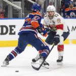 
              Florida Panthers' Sam Reinhart (13) tries to get past Edmonton Oilers' Brett Kulak (27) during first-period NHL hockey game action in Edmonton, Alberta, Monday, Nov. 28, 2022. (Jason Franson/The Canadian Press via AP)
            