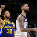 
              Golden State Warriors guard Stephen Curry (30) watches his 3-point basket, next to Minnesota Timberwolves guard Austin Rivers during the fourth quarter of an NBA basketball game Sunday, Nov. 27, 2022, in Minneapolis. (AP Photo/Andy Clayton-King)
            