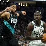 
              Milwaukee Bucks' Jrue Holiday (21) drives to the basket against Portland Trail Blazers' Trendon Watford (2) during the second half of an NBA basketball game Monday, Nov. 21, 2022, in Milwaukee. (AP Photo/Aaron Gash)
            