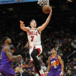 
              Chicago Bulls guard Goran Dragic (7) scores against Phoenix Suns forward Torrey Craig, left, and guard Damion Lee (10) during the second half of an NBA basketball game in Phoenix, Wednesday, Nov. 30, 2022. (AP Photo/Ross D. Franklin)
            