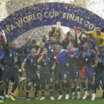 
              FILE - France goalkeeper Hugo Lloris holds the trophy aloft as he celebrates with his teammates after the final match between France and Croatia at the 2018 soccer World Cup in the Luzhniki Stadium in Moscow, Russia, Sunday, July 15, 2018. France won the final 4-2. (AP Photo/Matthias Schrader, File)
            