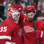 
              Detroit Red Wings center Dylan Larkin (71) pats goaltender Ville Husso (35) after an NHL hockey game against the Washington Capitals, Thursday, Nov. 3, 2022, in Detroit. The Red Wings won 3-1. (AP Photo/Carlos Osorio)
            