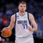
              Dallas Mavericks point guard Luka Doncic (77) shrugs to his teammates as he brings the ball up during the second half of an NBA basketball game against the Utah Jazz, Wednesday, Nov. 2, 2022, in Dallas. (AP Photo/Gareth Patterson)
            