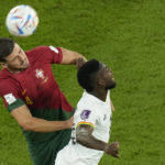 
              Portugal's Ruben Dias, left, and Ghana's Inaki Williams challenge for the ball during the World Cup group H soccer match between Portugal and Ghana, at the Stadium 974 in Doha, Qatar, Thursday, Nov. 24, 2022. (AP Photo/Francisco Seco)
            