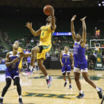 
              Baylor guard LJ Cryer (4) scores between McNeese State guard Rhyjon Blackwell (3) and forward Malachi Rhodes (23) in the second half of an NCAA college basketball game, Wednesday, Nov. 23, 2022, in Waco, Texas. (AP Photo/Rod Aydelotte)
            