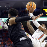 
              Auburn guard Wendell Green Jr. (1) shoots while falling, as Winthrop guard Isaiah Wilson (21) defends during the second half of an NCAA college basketball game Tuesday, Nov. 15, 2022, in Auburn, Ala. (AP Photo/Butch Dill)
            