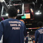 
              Members of the Virginia basketball team warm up Friday, Nov. 18, 2022, in Las Vegas for an NCAA college basketball game against Baylor, while wearing shirts in memory of the three students killed in a shooting nearly a week ago. (AP Photo/Chase Stevens)
            