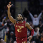 
              Cleveland Cavaliers guard Donovan Mitchell reacts after making a 3-point basket during the second half of an NBA basketball game against the Charlotte Hornets, Friday, Nov. 18, 2022, in Cleveland. (AP Photo/Ron Schwane)
            