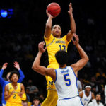 
              Michigan's Jett Howard (13) shoots over Pittsburgh's Nate Santos (5) during the first half of an NCAA basketball game at the Legends Classic Wednesday, Nov. 16, 2022, in New York. (AP Photo/Frank Franklin II)
            