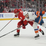 
              Detroit Red Wings defenseman Ben Chiarot (8) and New York Islanders left wing Matt Martin (17) battle for position in the first period of an NHL hockey game Saturday, Nov. 5, 2022, in Detroit. (AP Photo/Paul Sancya)
            