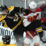 
              Boston Bruins defenseman Charlie McAvoy, left, slams into Calgary Flames right wing Tyler Toffoli, right, during the second period of an NHL hockey game, Thursday, Nov. 10, 2022, in Boston. (AP Photo/Charles Krupa)
            