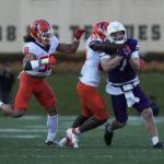 
              Northwestern quarterback Cole Freeman is tackled by Illinois defensive back Tyler Strain during the first half of an NCAA college football game in Evanston, Ill., Saturday, Nov. 26, 2022. (AP Photo/Nam Y. Huh)
            