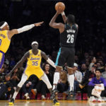 
              Portland Trail Blazers forward Justise Winslow, right, shoots as Los Angeles Lakers guard Russell Westbrook, left, and forward Wenyen Gabriel defend during the first half of an NBA basketball game Wednesday, Nov. 30, 2022, in Los Angeles. (AP Photo/Mark J. Terrill)
            