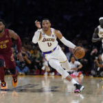 
              Los Angeles Lakers guard Russell Westbrook, center, dribbles past Cleveland Cavaliers guard Donovan Mitchell (45) during the first half of an NBA basketball game, Sunday, Nov. 6, 2022, in Los Angeles. (AP Photo/Marcio Jose Sanchez)
            