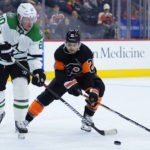 
              Dallas Stars' Ryan Suter, left, tries to clear the puck away from Philadelphia Flyers' Scott Laughton during the second period of an NHL hockey game, Sunday, Nov. 13, 2022, in Philadelphia. (AP Photo/Matt Slocum)
            