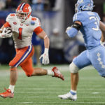 
              Clemson running back Will Shipley (1) carries while pursued by North Carolina defensive back Will Hardy (31) during the first half of the the Atlantic Coast Conference championship NCAA college football game Saturday, Dec. 3, 2022, in Charlotte, N.C. (AP Photo/Jacob Kupferman)
            