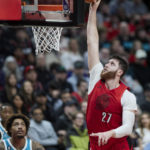 
              Portland Trail Blazers center Jusuf Nurkic, right, dunks in front of Charlotte Hornets guard Kelly Oubre Jr. during the second half of an NBA basketball game in Portland, Ore., Monday, Dec. 26, 2022. (AP Photo/Craig Mitchelldyer)
            
