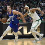 
              Los Angeles Clippers' Luke Kennard (5) drives past Boston Celtics' Derrick White during first half of an NBA basketball game Monday, Dec. 12, 2022, in Los Angeles. (AP Photo/Jae C. Hong)
            