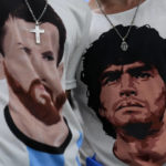 
              Fans of Argentina wear t-shirts of Lionel Messi, left, and Diego Maradona prior to the World Cup semifinal soccer match between Argentina and Croatia at the Lusail Stadium in Lusail, Qatar, Tuesday, Dec. 13, 2022. (AP Photo/Natacha Pisarenko)
            