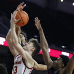 
              Oregon State forward Michael Rataj, top left, blocks a shot by Southern California guard Drew Peterson, center, with Oregon State guard Dexter Akanno, right, defending during the second half of an NCAA college basketball game in Los Angeles, Sunday, Dec. 4, 2022. (AP Photo/Alex Gallardo)
            