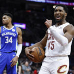 
              Cleveland Cavaliers guard Donovan Mitchell (45) celebrates after being fouled as Milwaukee Bucks forward Giannis Antetokounmpo (34) looks away during the second half of an NBA basketball game Wednesday, Dec. 21, 2022, in Cleveland. (AP Photo/Ron Schwane)
            