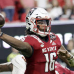 
              FILE- North Carolina State quarterback MJ Morris (16) passes during the second half of an NCAA college football game against Boston College Saturday, Nov. 12, 2022, in Raleigh, N.C. NC State takes on Maryland in Duke's Mayo Bowl. (AP Photo/Chris Seward, File)
            