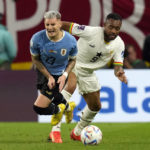 
              Ghana's Jordan Ayew, right, and Uruguay's Guillermo Varela fight for the ball during the World Cup group H soccer match between Ghana and Uruguay, at the Al Janoub Stadium in Al Wakrah, Qatar, Friday, Dec. 2, 2022. (AP PhotoThemba Hadebe)
            