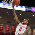 
              Houston guard Marcus Sasser (0) scores on a fast break during the first half of an NCAA college basketball game against North Florida, Tuesday, Dec. 6, 2022, in Houston. (AP Photo/Kevin M. Cox)
            