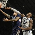
              Connecticut guard Jordan Hawkins, left, is fouled while shooting by Butler center Manny Bates in the second half of an NCAA college basketball game in Indianapolis, Saturday, Dec. 17, 2022. (AP Photo/AJ Mast)
            