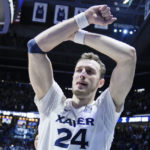 
              Xavier's Jack Nunge (24) gestures to the crowd after defeating Connecticut in an NCAA college basketball game, Saturday, Dec. 31, 2022, in Cincinnati. (AP Photo/Jeff Dean)
            