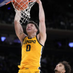 
              Iowa's Filip Rebraca (0) dunks during the second half of an NCAA college basketball game against Duke in the Jimmy V Classic, Tuesday, Dec. 6, 2022, in New York. (AP Photo/John Minchillo)
            