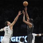 
              Brooklyn Nets forward Kevin Durant (7) shoots against Milwaukee Bucks center Brook Lopez (11) during the first half of an NBA basketball game, Friday, Dec. 23, 2022, in New York. (AP Photo/Jessie Alcheh)
            