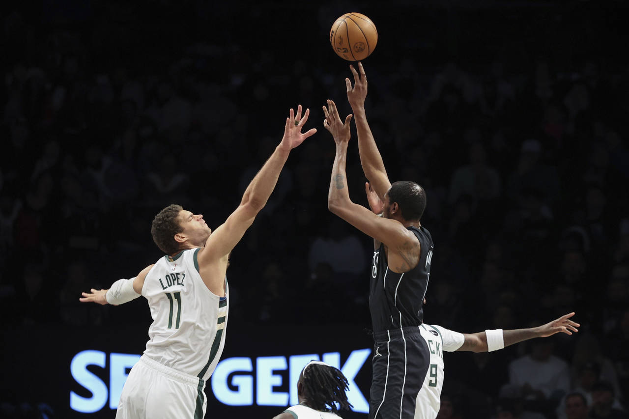 Brooklyn Nets forward Kevin Durant (7) shoots against Milwaukee Bucks center Brook Lopez (11) durin...