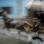
              A horse pulls a buggy with passengers through a street flooded by heavy rains, in Havana, Cuba, on June 3, 2022. (AP Photo/Ramon Espinosa)
            