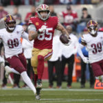 
              San Francisco 49ers tight end George Kittle (85) rushes the ball past Washington Commanders defensive end James Smith-Williams (96) and safety Jeremy Reaves (39) in the second half of an NFL football game, Saturday, Dec. 24, 2022, in Santa Clara, Calif. (AP Photo/Godofredo A. Vásquez)
            