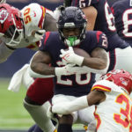 
              Houston Texans running back Royce Freeman (26) is stopped by Kansas City Chiefs linebacker Willie Gay (50) and cornerback L'Jarius Sneed (38) during the first half of an NFL football game Sunday, Dec. 18, 2022, in Houston. (AP Photo/Eric Christian Smith)
            