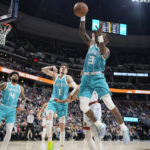 
              Charlotte Hornets guard Terry Rozier pulls in a loose ball in the first half of an NBA basketball game against the Denver Nuggets, Sunday, Dec. 18, 2022, in Denver. (AP Photo/David Zalubowski)
            