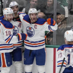 
              Edmonton Oilers' Zach Hyman (18), Darnell Nurse (25) and Connor McDavid (97) celebrate with Jesse Puljujarvi (13) aftger McDavid scored against the Dallas Stars during the third period of an NHL hockey game Wednesday, Dec. 21, 2022, in Dallas. (AP Photo/Tony Gutierrez)
            