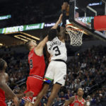 
              Minnesota Timberwolves forward Jaden McDaniels (3) goes up to the basket against Chicago Bulls center Nikola Vucevic (9) during the second half of an NBA basketball game Sunday, Dec. 18, 2022, in Minneapolis. (AP Photo/Stacy Bengs)
            