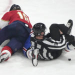
              Lineman Ryan Jackson, right, grabs his knee after falling to the ice as Florida Panthers defenseman Marc Staal (18) and Montreal Canadiens defenseman Joel Edmundson fight during the third period of an NHL hockey game, Thursday, Dec. 29, 2022, in Sunrise, Fla. The Panthers won 7-2. (AP Photo/Lynne Sladky)
            
