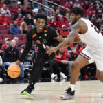 
              Miami forward Anthony Walker (1) drives around Louisville forward Sydney Curry (21) during the first half of an NCAA college basketball game in Louisville, Ky., Sunday, Dec. 4, 2022. (AP Photo/Timothy D. Easley)
            