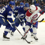 
              Montreal Canadiens right wing Cole Caufield (22) works the puck against Tampa Bay Lightning defenseman Nick Perbix (48) and defenseman Mikhail Sergachev (98) during the first period of an NHL hockey game Wednesday, Dec. 28, 2022, in Tampa, Fla. (AP Photo/Chris O'Meara)
            