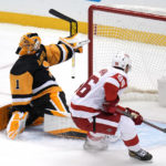 
              Detroit Red Wings' Jake Walman backhands a shot past Pittsburgh Penguins goaltender Casey DeSmith for an overtime goal during an NHL hockey game in Pittsburgh, Wednesday, Dec. 28, 2022. The Red Wings won 5-4. (AP Photo/Gene J. Puskar)
            