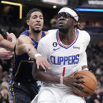 
              LA Clippers' Reggie Jackson (1) goes to the basket against Indiana Pacers' Tyrese Haliburton (0) during the second half of an NBA basketball game, Saturday, Dec. 31, 2022, in Indianapolis. (AP Photo/Darron Cummings)
            