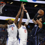 
              Orlando Magic forward Paolo Banchero shoots over Los Angeles Clippers forward Kawhi Leonard (2) and guard Paul George (13) during the first half of an NBA basketball game Wednesday, Dec. 7, 2022, in Orlando, Fla. (AP Photo/Scott Audette)
            