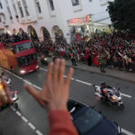 
              The players of Morocco national soccer team celebrate on a bus and wave to the public during a homecoming parade in central Rabat, Morocco, Tuesday, Dec. 20, 2022. Morocco national team won the fourth place at the last World Cup. (AP Photo/Mosa'ab Elshamy)
            